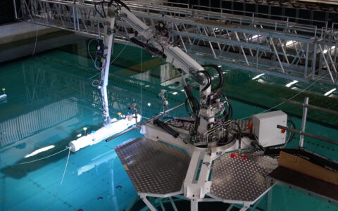 Photograph of Proteus 100 lifting model AUV during wave tank testing.